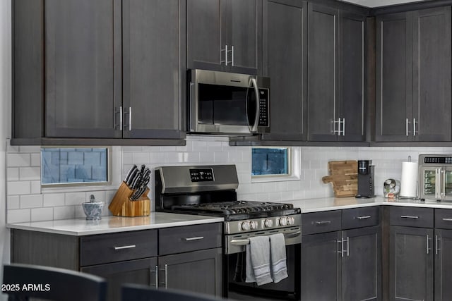 4352 N 91st Gln, Phoenix, AZ 85037 - kitchen featuring appliances with stainless steel finishes, backsplash, and light countertops