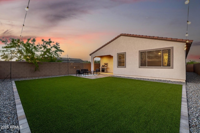 4352 N 91st Gln, Phoenix, AZ 85037 - back of property featuring stucco siding, a patio, and a tiled roof