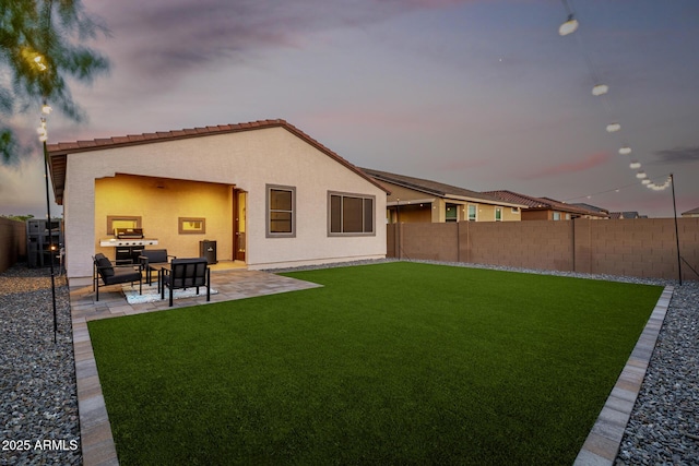 4352 N 91st Gln, Phoenix, AZ 85037 - back of house with stucco siding and a patio area