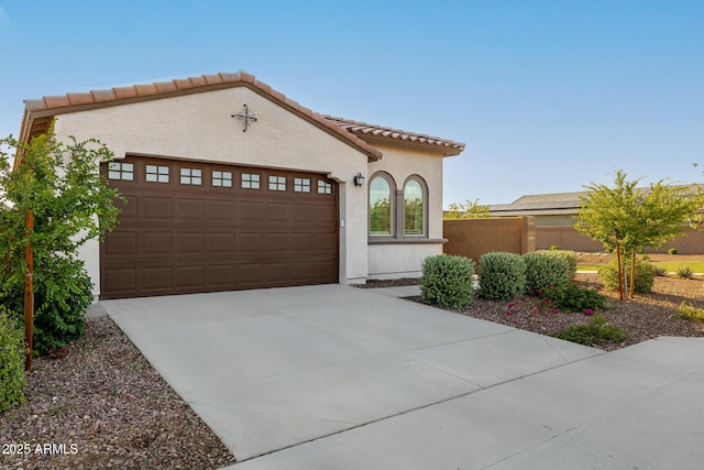 4352 N 91st Gln, Phoenix, AZ 85037 - mediterranean / spanish home with stucco siding, a garage, concrete driveway, a tile roof, and fence
