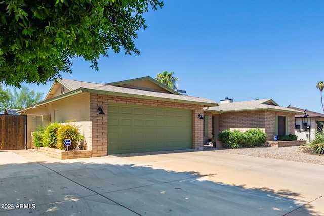 ranch-style house with an attached garage, brick siding, and driveway