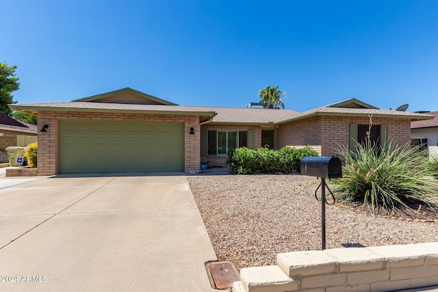 ranch-style home with brick siding, concrete driveway, a garage, and roof with shingles