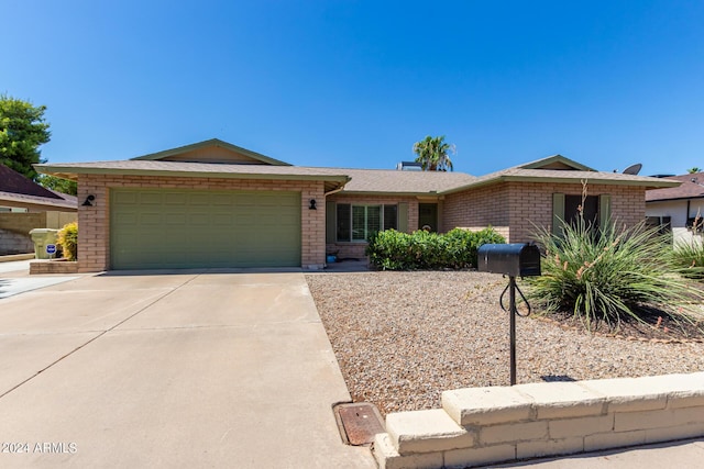 single story home featuring brick siding, an attached garage, and concrete driveway