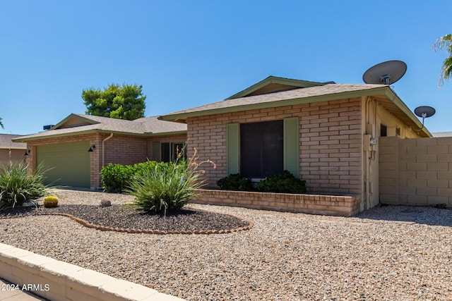 ranch-style home with an attached garage and brick siding