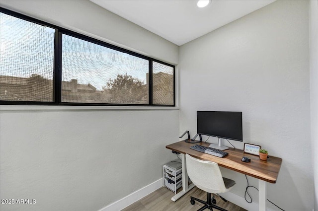 office with light wood-type flooring