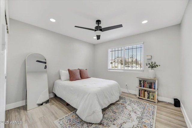 bedroom with ceiling fan and light hardwood / wood-style floors