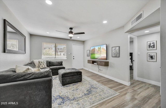 living room with ceiling fan and hardwood / wood-style floors