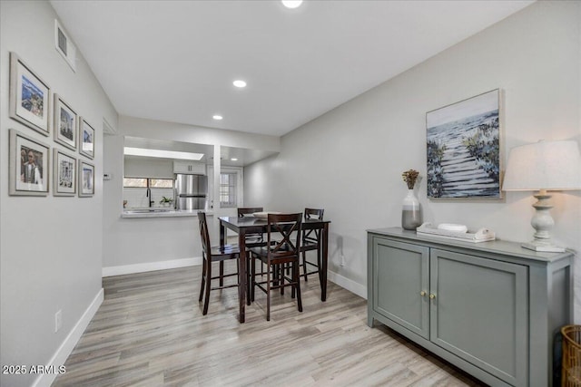 dining room with light wood-type flooring