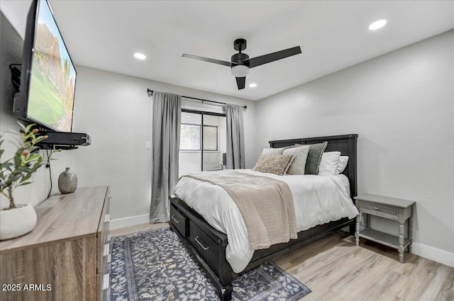 bedroom with ceiling fan and light hardwood / wood-style flooring