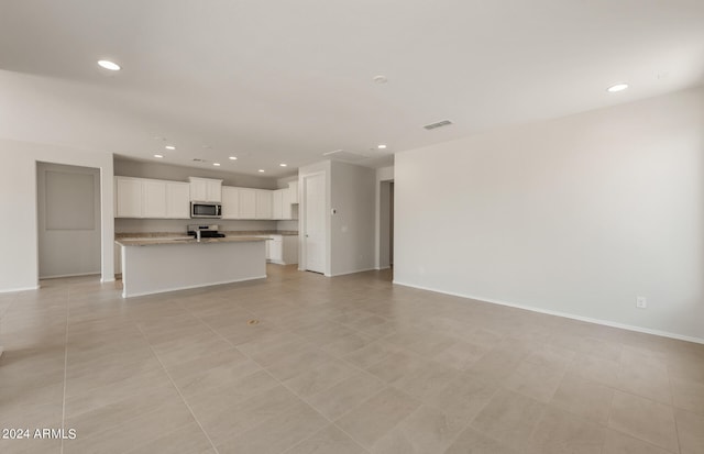 unfurnished living room with light tile patterned flooring