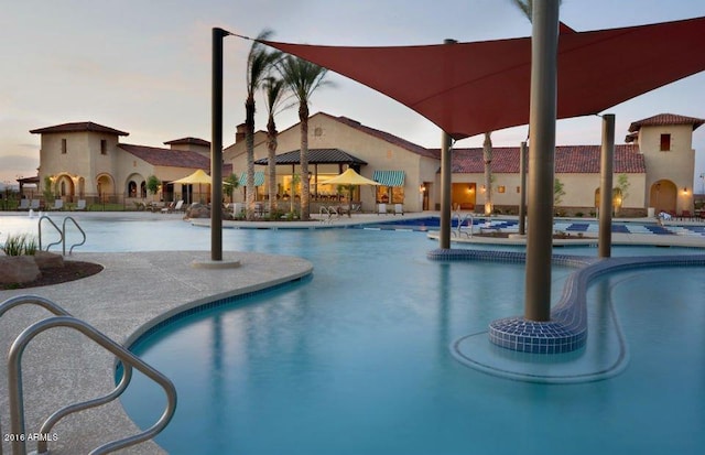 pool at dusk with a patio