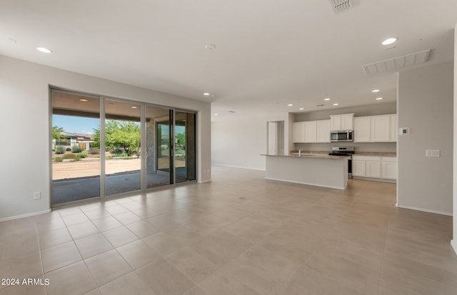 unfurnished living room featuring light tile patterned floors