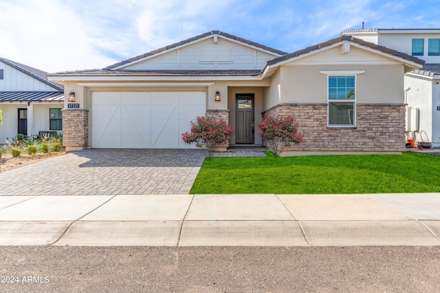 view of front of property with a front lawn and a garage