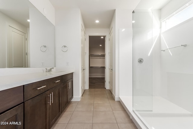 bathroom with vanity, a shower with door, and tile flooring