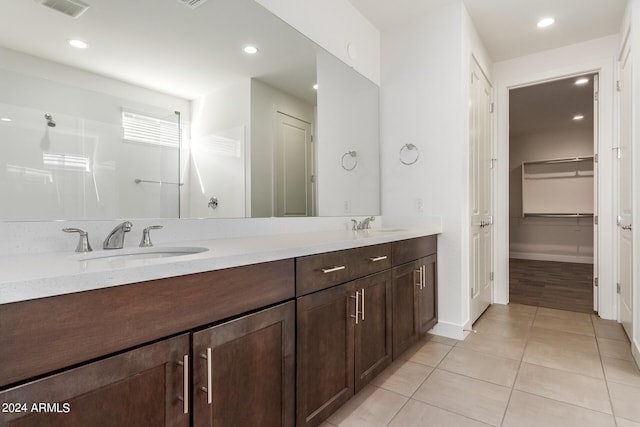 bathroom with tile flooring and dual bowl vanity