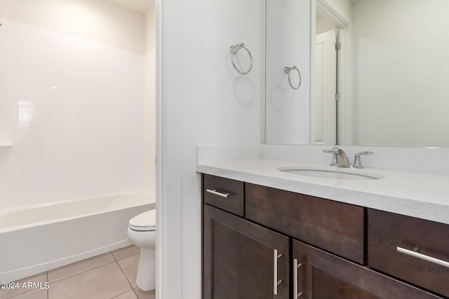 full bathroom featuring  shower combination, toilet, tile floors, and vanity with extensive cabinet space