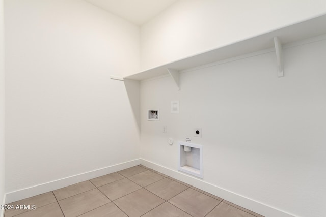 laundry room with hookup for a gas dryer, hookup for an electric dryer, light tile floors, and hookup for a washing machine