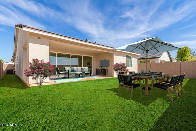 rear view of house with central AC unit, an outdoor hangout area, a yard, and a patio area