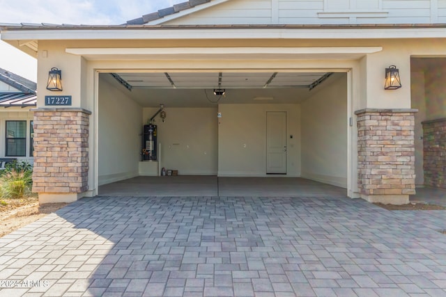 garage with a carport and water heater