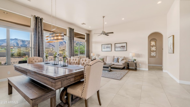 9864 E Baseline Ave, Gold Canyon, AZ 85118 - dining space featuring ceiling fan, arched walkways, recessed lighting, a mountain view, and light tile patterned flooring