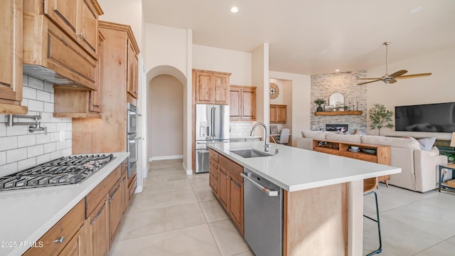 9864 E Baseline Ave, Gold Canyon, AZ 85118 - kitchen featuring stainless steel appliances, ceiling fan, decorative backsplash, open floor plan, and a breakfast bar area
