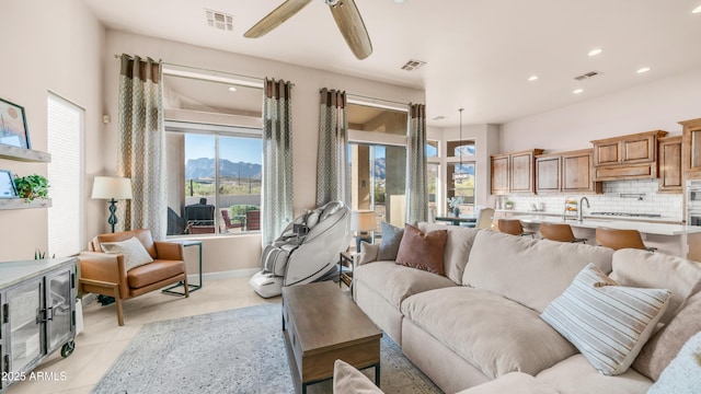 9864 E Baseline Ave, Gold Canyon, AZ 85118 - living area with healthy amount of natural light, ceiling fan, recessed lighting, light tile patterned flooring, and a mountain view