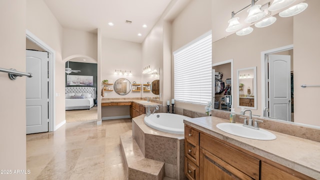 9864 E Baseline Ave, Gold Canyon, AZ 85118 - bathroom featuring a garden tub, vanity, connected bathroom, a closet, and a towering ceiling