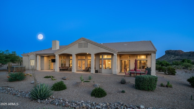 9864 E Baseline Ave, Gold Canyon, AZ 85118 - rear view of property featuring stucco siding, a chimney, a mountain view, and a patio
