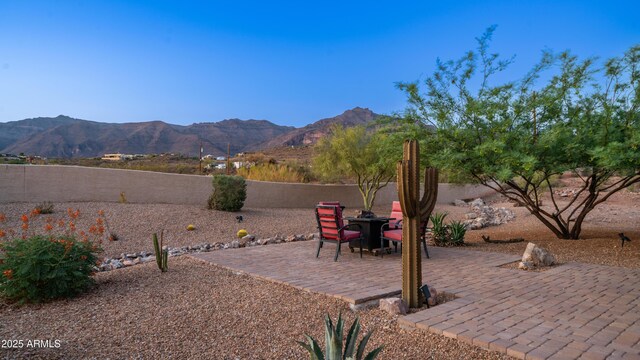 9864 E Baseline Ave, Gold Canyon, AZ 85118 - fenced backyard with a mountain view and a patio area