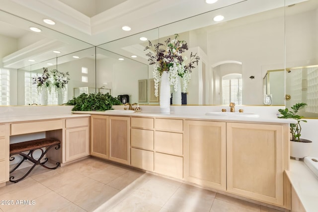 bathroom with an enclosed shower, vanity, and tile patterned floors