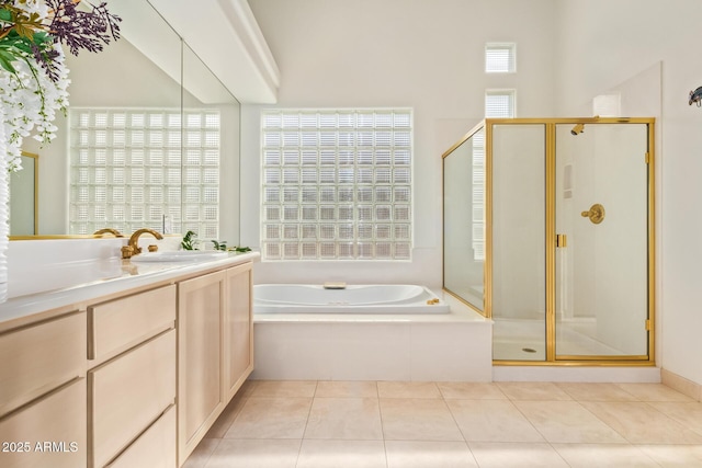 bathroom with tile patterned flooring, vanity, and plus walk in shower