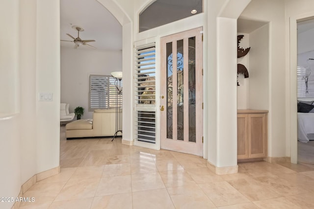 foyer entrance featuring ceiling fan and light tile patterned floors