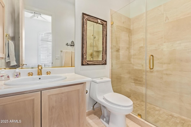 bathroom featuring vanity, toilet, and an enclosed shower