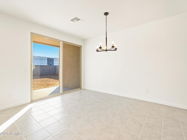 spare room with light tile patterned floors and a notable chandelier