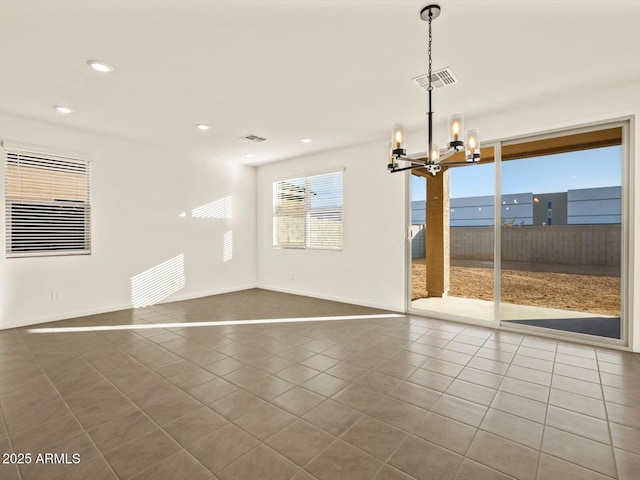 interior space featuring a chandelier, tile patterned flooring, and a water view