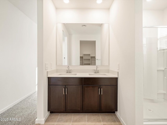 bathroom featuring vanity, a shower, and tile patterned floors