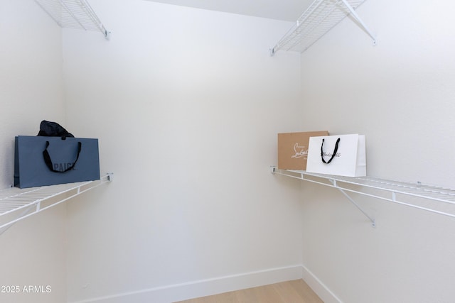 walk in closet featuring hardwood / wood-style floors