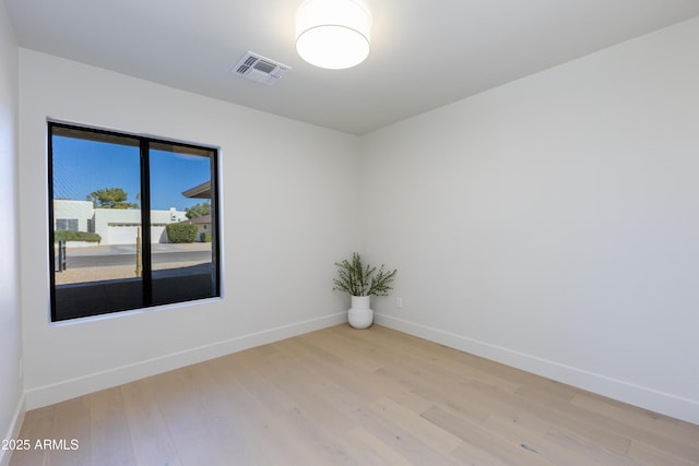 unfurnished room with light hardwood / wood-style floors