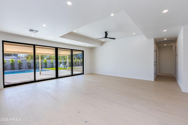 spare room featuring ceiling fan and light hardwood / wood-style flooring