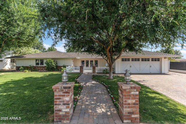 3817 E Highland Ave, Phoenix, AZ 85018 - ranch-style home featuring an attached garage, board and batten siding, and driveway