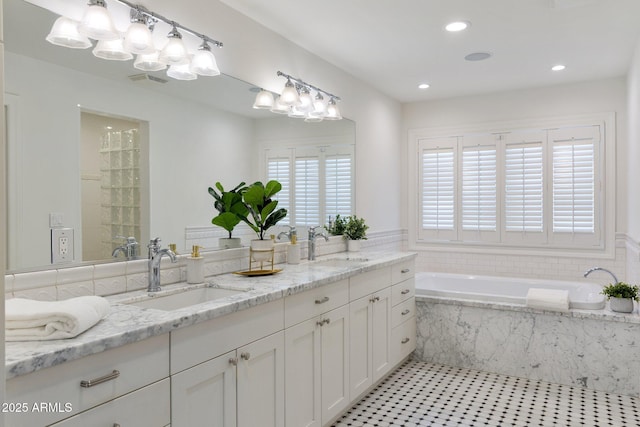 3817 E Highland Ave, Phoenix, AZ 85018 - bathroom with double vanity, plenty of natural light, a garden tub, and recessed lighting