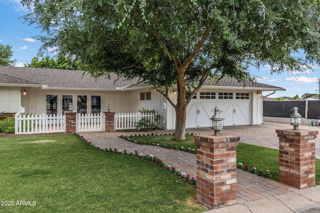 3817 E Highland Ave, Phoenix, AZ 85018 - ranch-style home with board and batten siding, driveway, a garage, and a shingled roof