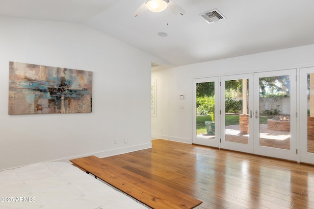 3817 E Highland Ave, Phoenix, AZ 85018 - empty room with lofted ceiling, french doors, a ceiling fan, baseboards, and wood finished floors