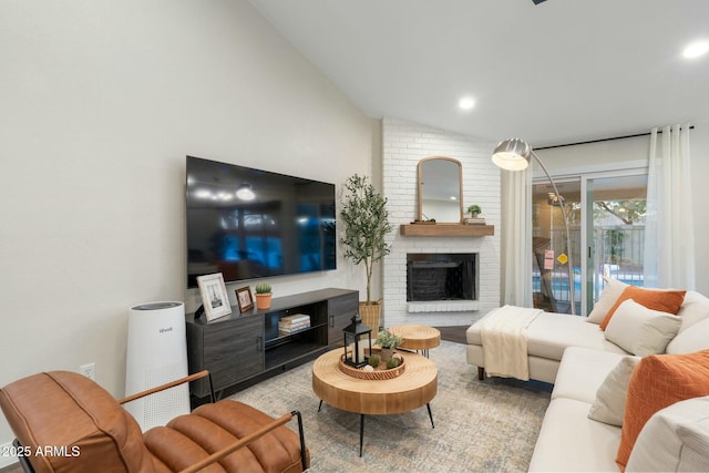 living room with a brick fireplace and vaulted ceiling