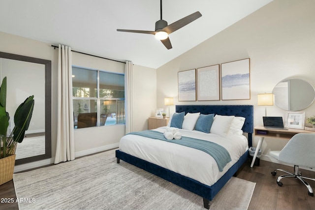 bedroom featuring hardwood / wood-style floors, vaulted ceiling, and ceiling fan