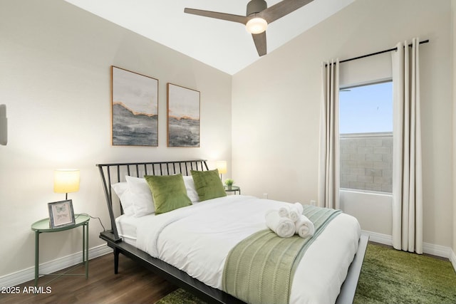 bedroom with dark hardwood / wood-style flooring, ceiling fan, and lofted ceiling