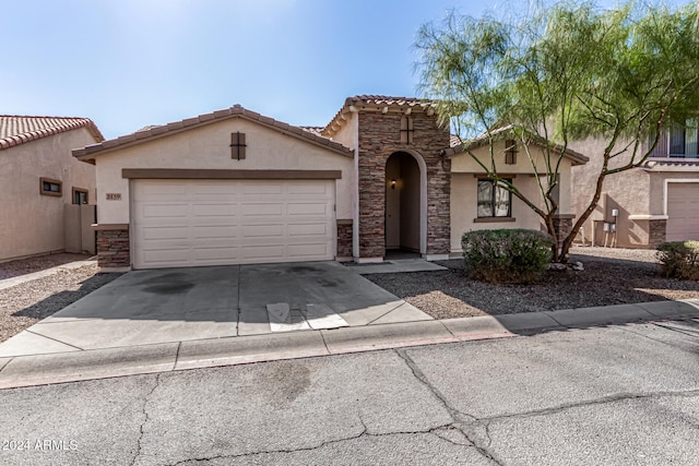 mediterranean / spanish-style home with a garage