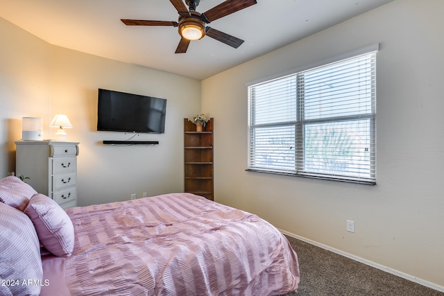 bedroom with ceiling fan, multiple windows, and carpet flooring