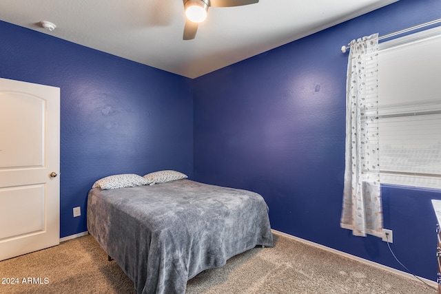 bedroom featuring ceiling fan and carpet