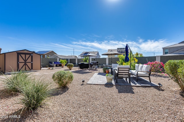 view of yard featuring an outdoor hangout area, a storage unit, and a patio area